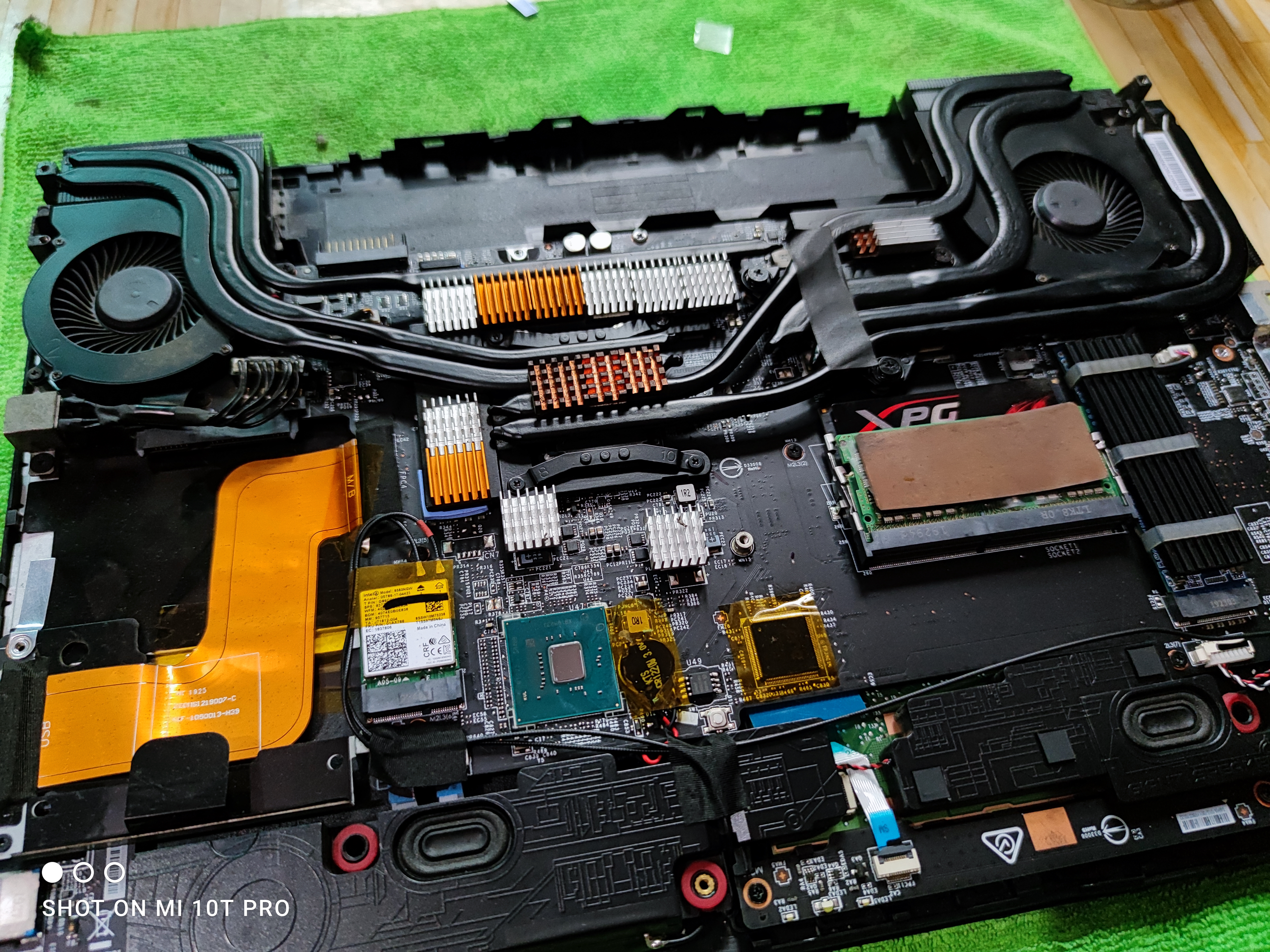 ModMyLaptop — gaming laptop fully disassembled showing heatpipes, VRM and XPG RAM